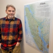 Jeff Clark with his map of Vancouver Island, The Essential Geography of Vancouver Island. Clark used a combination of traditional analytical shaded relief blended with a 3D rendered elevation model to create a visually textured landscape. DARREN STONE, TIMES COLONIST